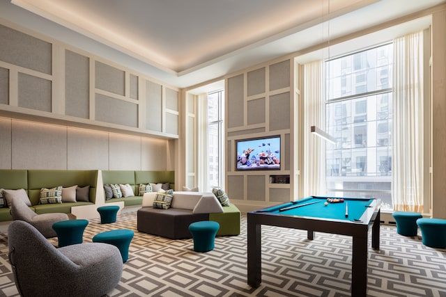 game room with pool table and a towering ceiling