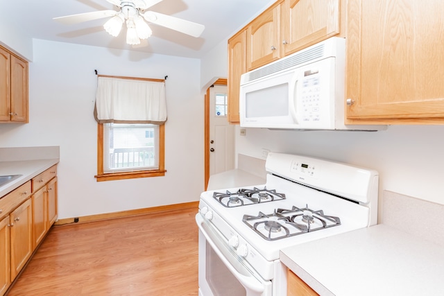 kitchen with ceiling fan, light brown cabinets, light hardwood / wood-style floors, and white appliances