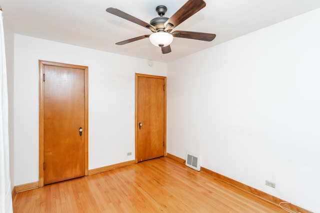 unfurnished bedroom featuring ceiling fan, light hardwood / wood-style flooring, and a closet