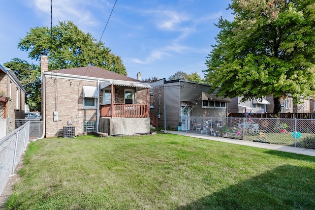 exterior space featuring a yard and central AC