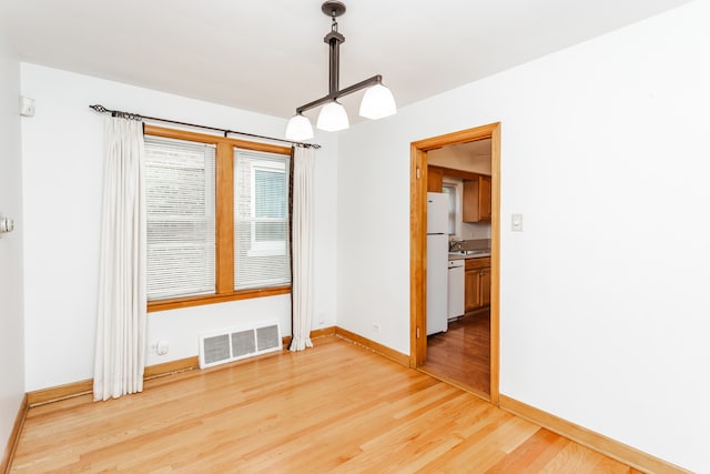 unfurnished dining area with hardwood / wood-style floors