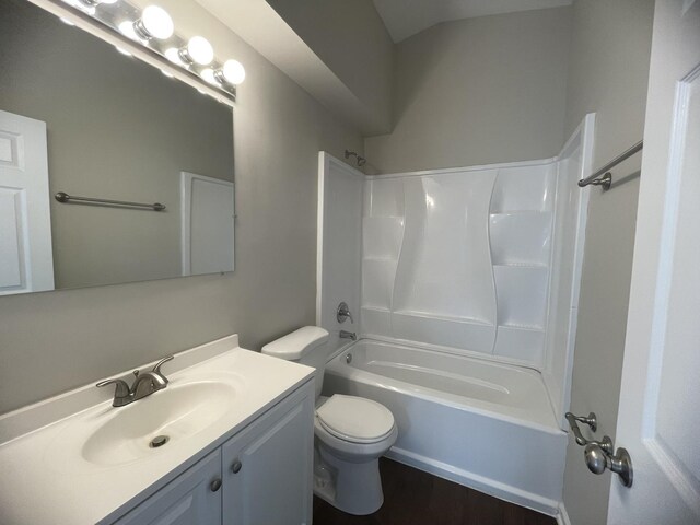 full bathroom with wood-type flooring, toilet, bathing tub / shower combination, and vanity