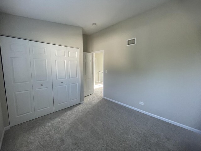 unfurnished bedroom featuring carpet floors and a closet