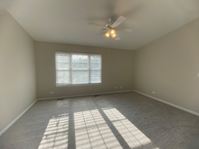 spare room with ceiling fan and carpet flooring