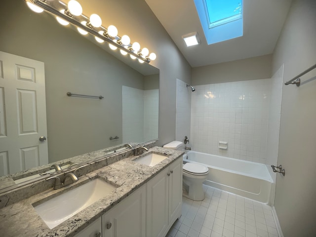 full bathroom with vanity, toilet, tiled shower / bath combo, and vaulted ceiling with skylight