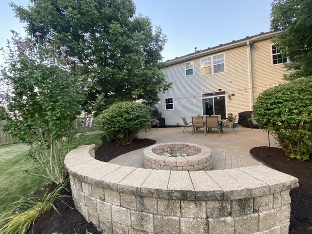 back of house featuring a patio area and an outdoor fire pit