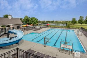 view of pool with a patio and a water slide