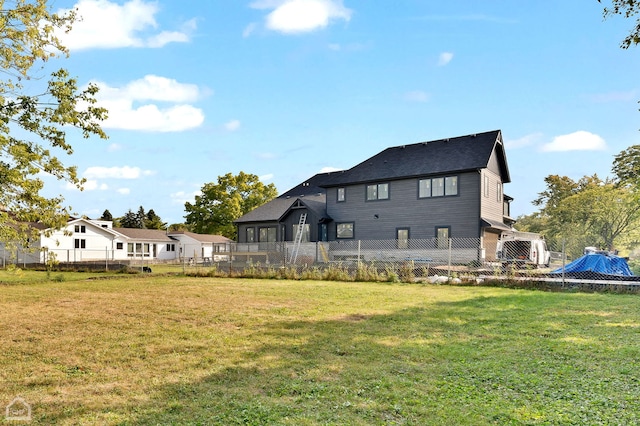 rear view of property with a yard