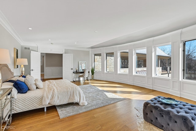 bedroom featuring light wood-type flooring and crown molding