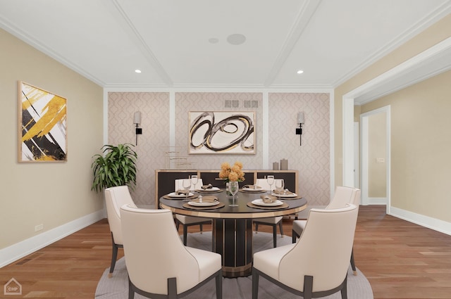 dining room with ornamental molding and hardwood / wood-style floors