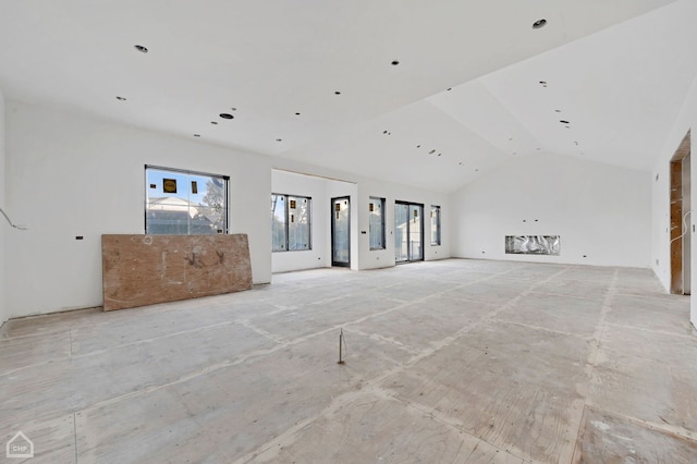 unfurnished living room with lofted ceiling