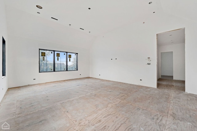 empty room featuring high vaulted ceiling