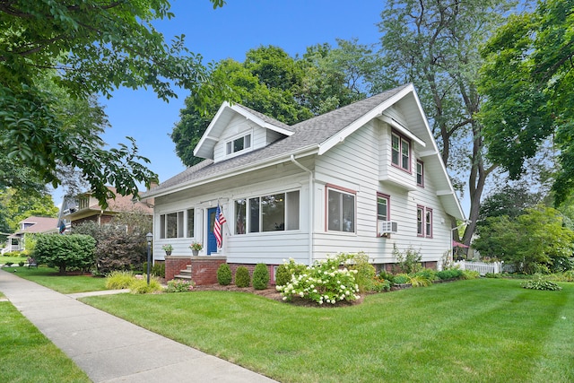 view of front of house with cooling unit and a front yard