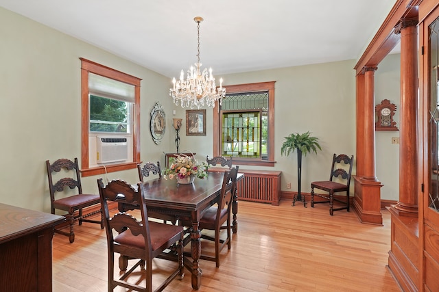 dining space featuring a notable chandelier, radiator, light hardwood / wood-style floors, and cooling unit