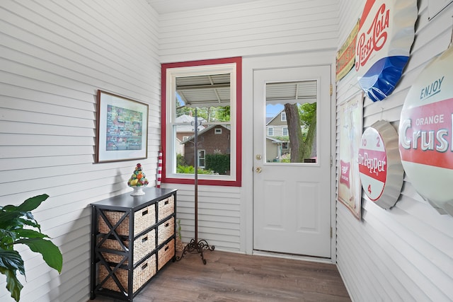 entryway featuring wooden walls and dark hardwood / wood-style flooring