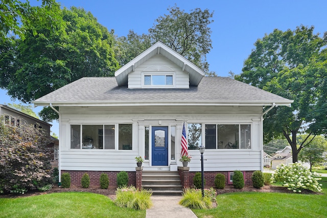 bungalow-style house with a front lawn