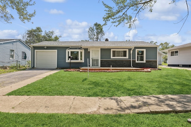 ranch-style house featuring a front lawn and a garage