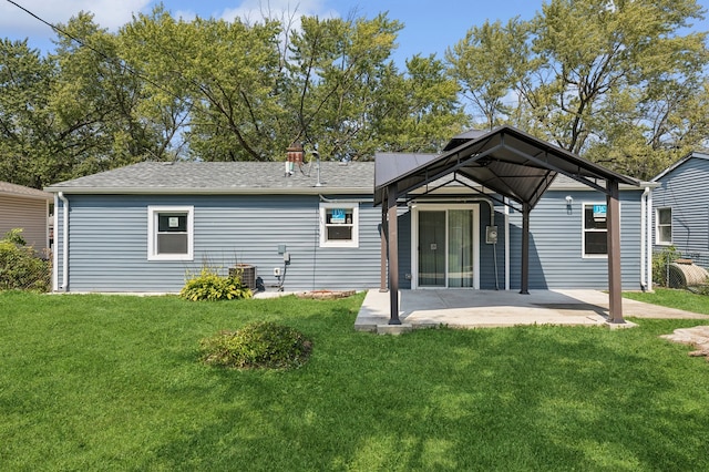 back of property featuring a patio area and a lawn