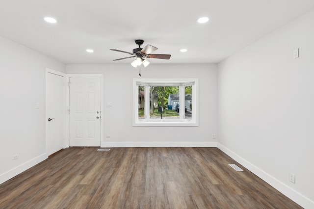 unfurnished room with ceiling fan and dark hardwood / wood-style floors