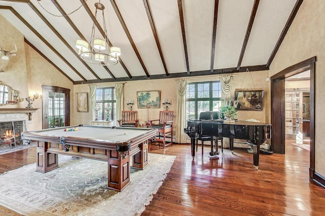 recreation room with beam ceiling, a healthy amount of sunlight, high vaulted ceiling, and dark wood-type flooring