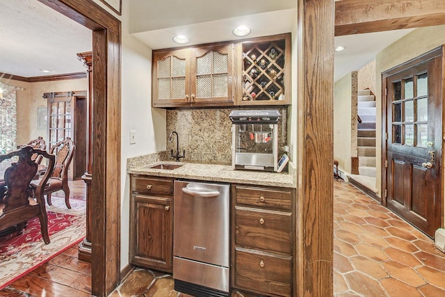 bar featuring crown molding, sink, backsplash, stainless steel dishwasher, and light stone counters