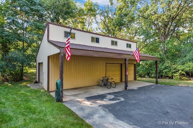 exterior space featuring a garage and a front yard