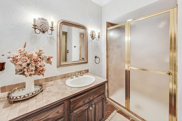 bathroom featuring vanity and a shower with shower door