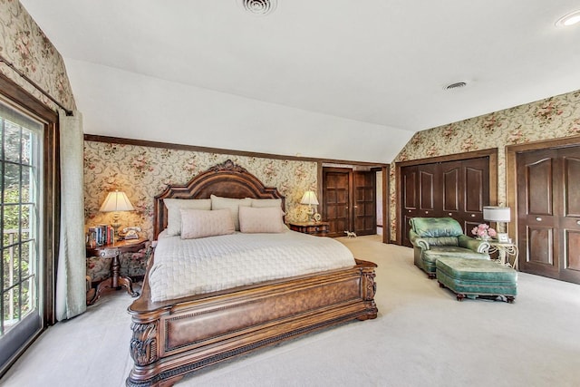 carpeted bedroom with lofted ceiling and access to exterior