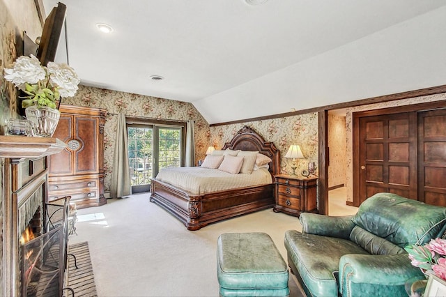 bedroom featuring lofted ceiling, light carpet, and access to outside