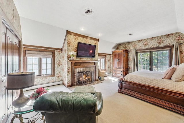 carpeted bedroom featuring lofted ceiling and a baseboard heating unit