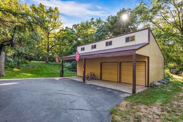 garage with wooden walls and a lawn