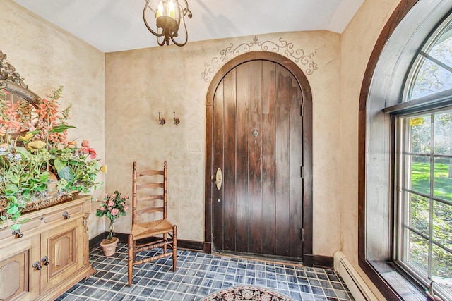 entryway featuring lofted ceiling and baseboard heating