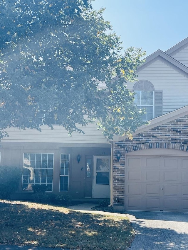 view of front of house with brick siding and a garage
