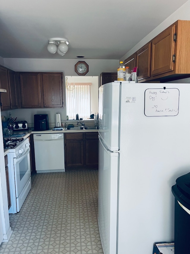 kitchen with sink and white appliances