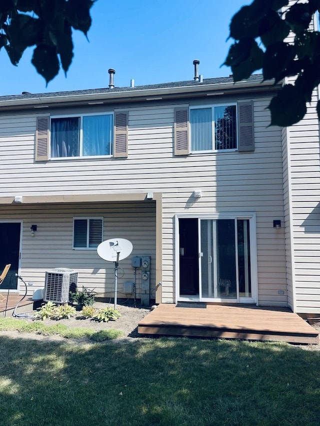 back of house with a wooden deck, a yard, and central air condition unit