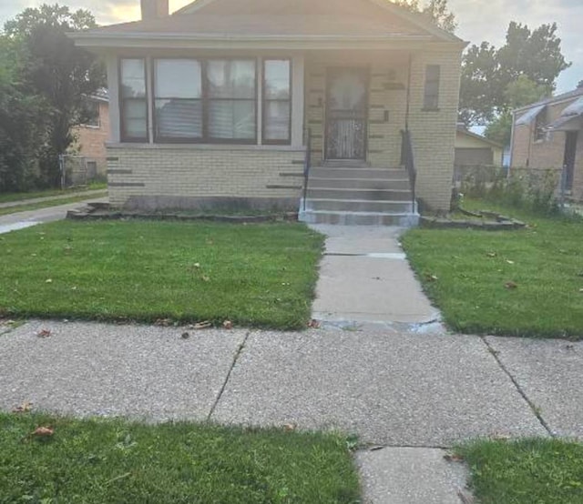 bungalow-style house featuring a front yard