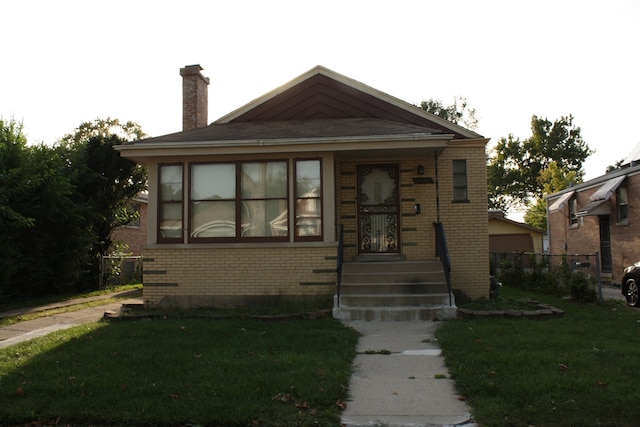 bungalow-style house with a front yard