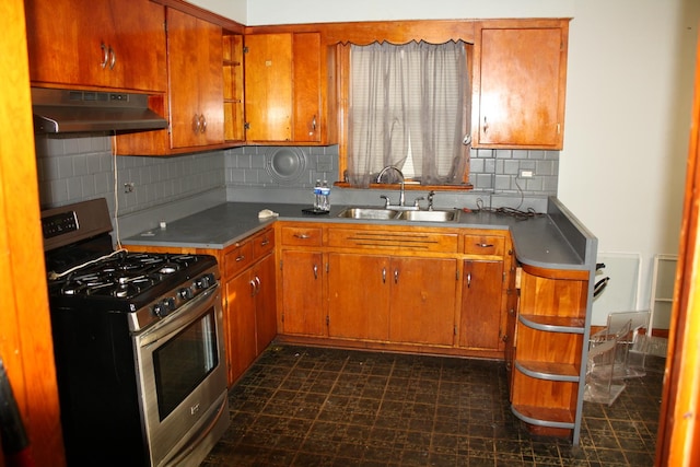 14420 S Lowe Ave, Riverdale, IL 60827 - kitchen with under cabinet range hood, stainless steel gas stove, a sink, and tasteful backsplash