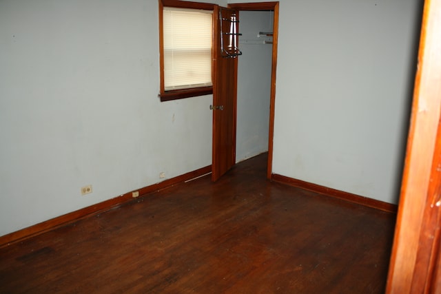 empty room with dark hardwood / wood-style floors