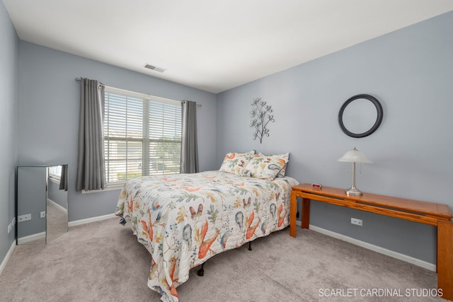 bedroom with carpet flooring, visible vents, and baseboards