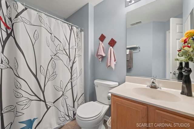 full bathroom with toilet, vanity, and visible vents