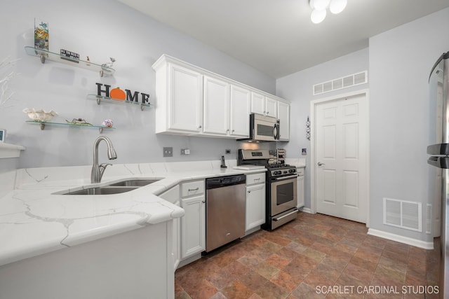 kitchen with white cabinets, visible vents, stainless steel appliances, and a sink