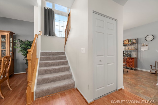 stairs featuring baseboards and wood finished floors