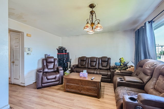 living room with light wood-type flooring and a notable chandelier