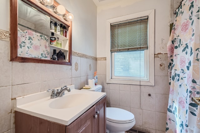 bathroom featuring vanity, toilet, a shower with shower curtain, and tile walls