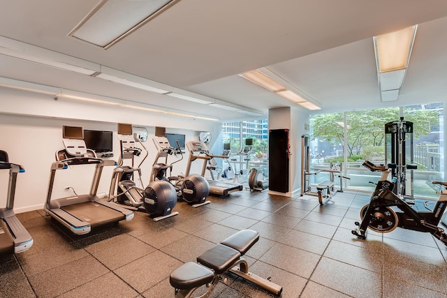 exercise room with a wall of windows and a healthy amount of sunlight