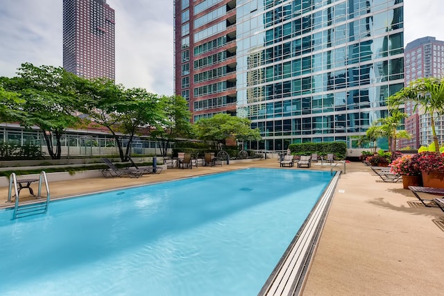 view of swimming pool featuring a patio area