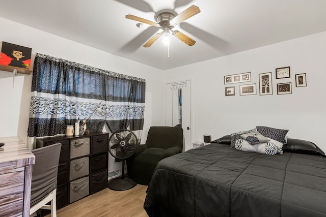 bedroom with light hardwood / wood-style floors and ceiling fan