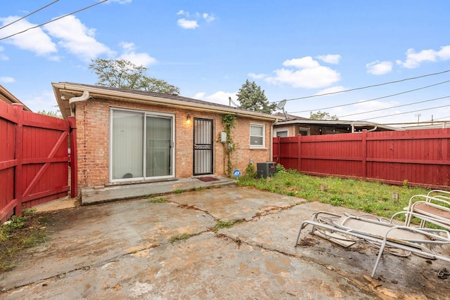 rear view of property with a patio and central AC