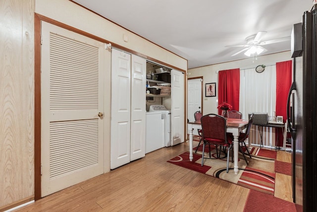 dining room with washing machine and clothes dryer, light hardwood / wood-style floors, and ceiling fan